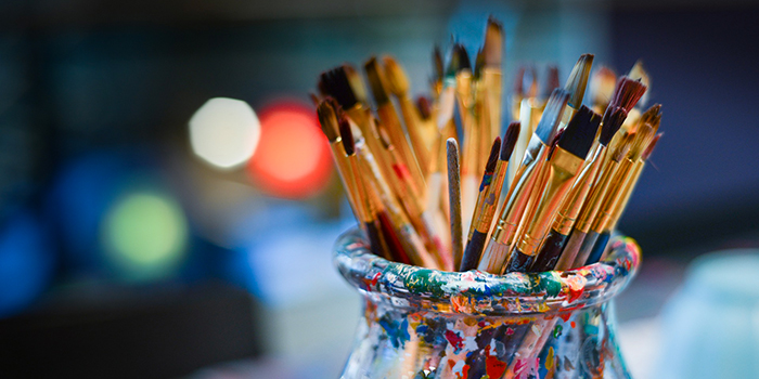 Image de pinceaux d'art vibrant de couleurs dans un vase, symbolisant la créativité et l'inspiration artistique. Plongez dans cet univers de couleurs et de créativité.